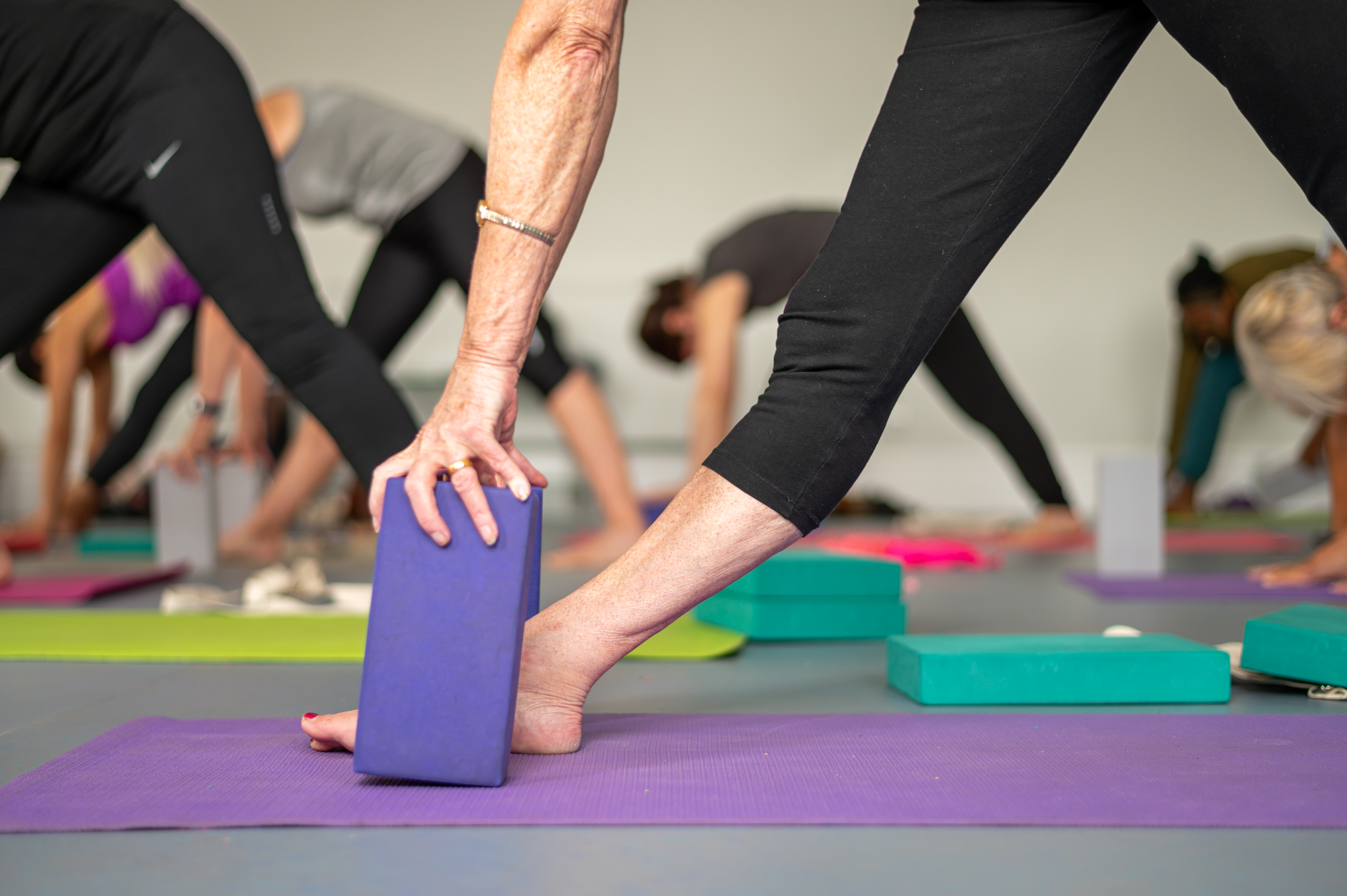 Feet and support blocks during a yoga class