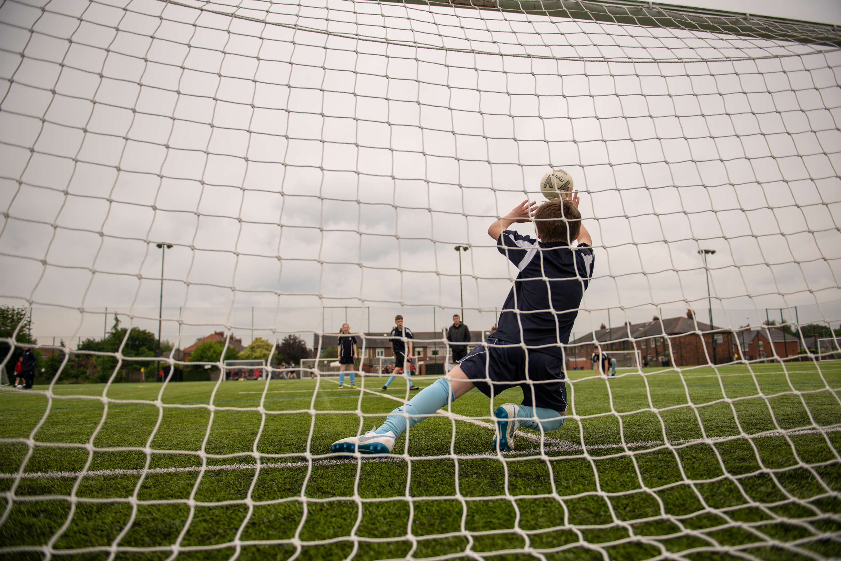 Child trying to save a football shot 