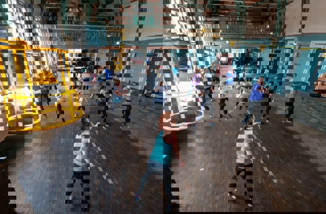 Overhead view of a group dance exercise class in a community centre