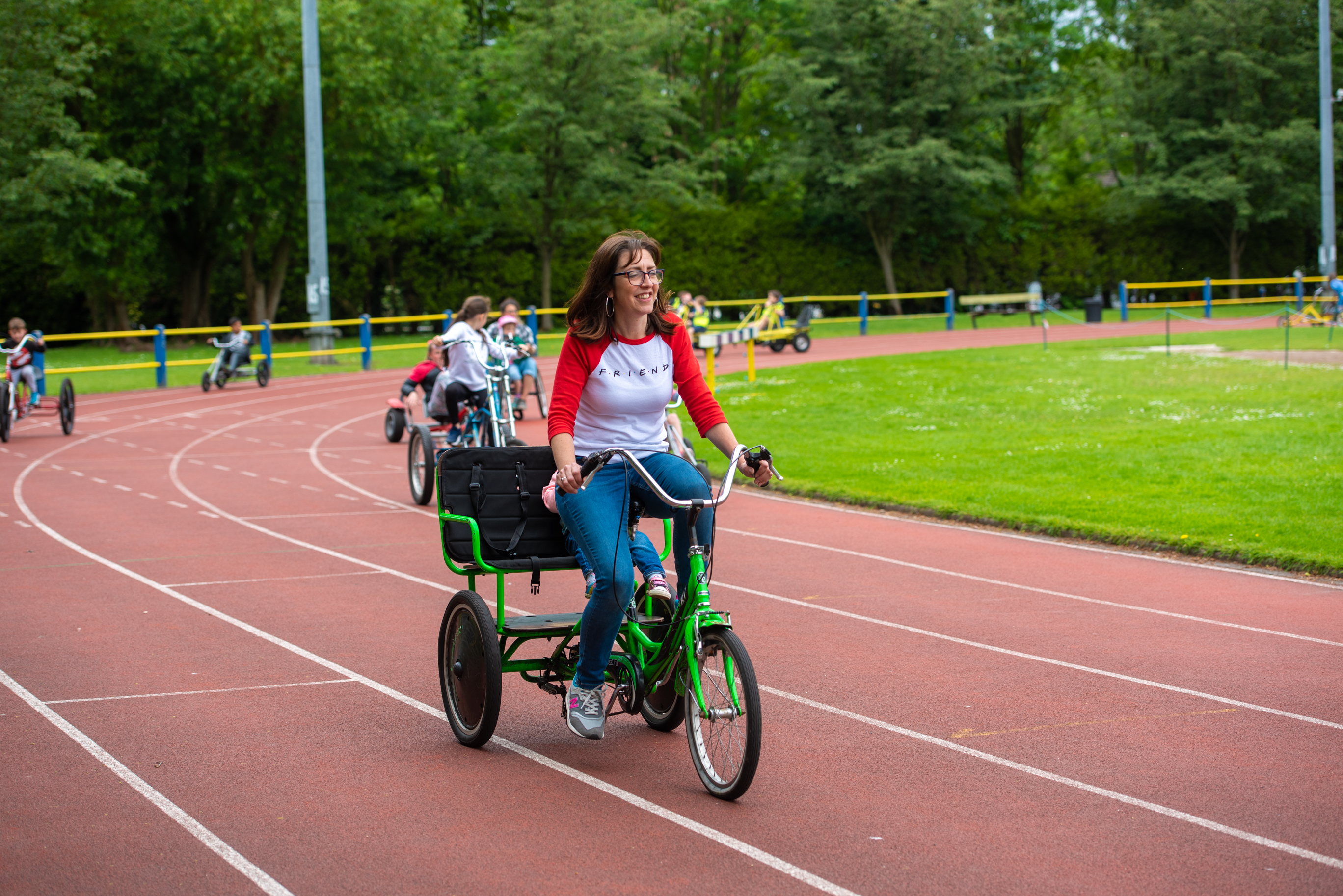 Woman on family bike with child on seat behind