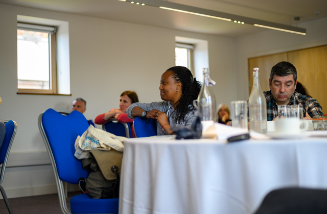 People sat around tables at a workshop