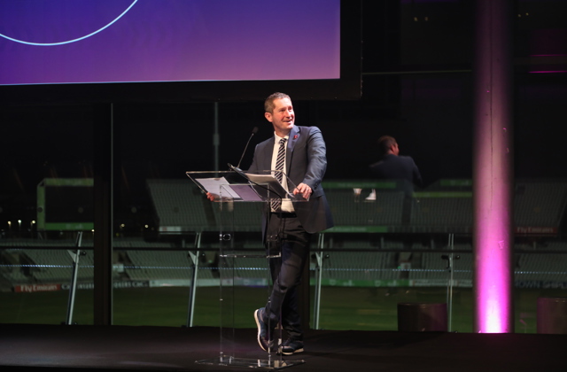 Mike Perls speaking behind lectern at the GM Sports Awards