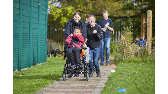Adults and young people taking part in the daily mile on an outdoor path