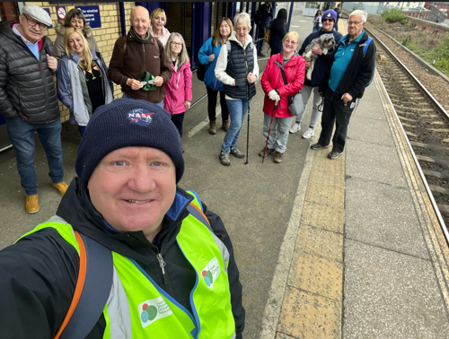 HMR Circle director Mark Wynn takes a selfie with walkers at a train station
